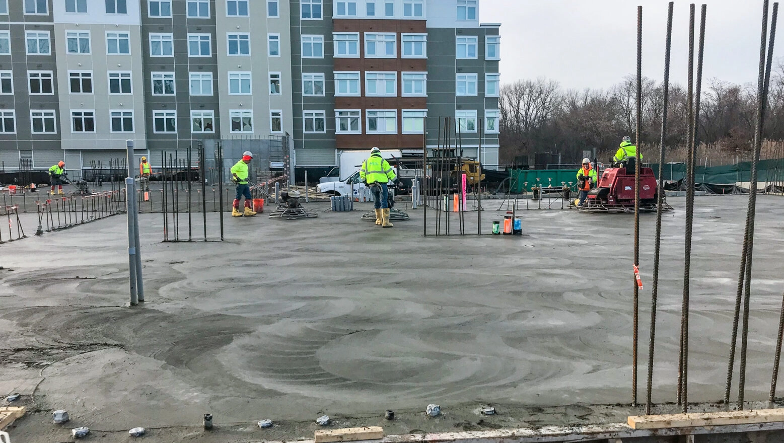 Dex by Terra workers performing Concrete Finishing on concrete slab in Massachusetts.