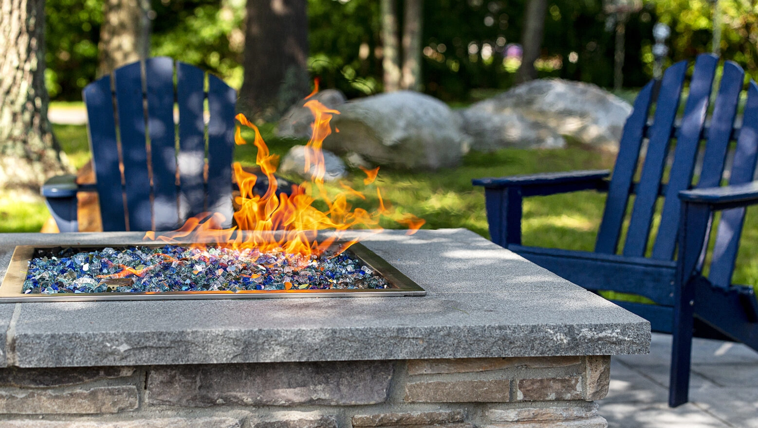 Fire pit with chairs in amenity area at Cranmore Ridge Apartments in Concord, NH. Dex by Terra Masonry & Hardscape project.