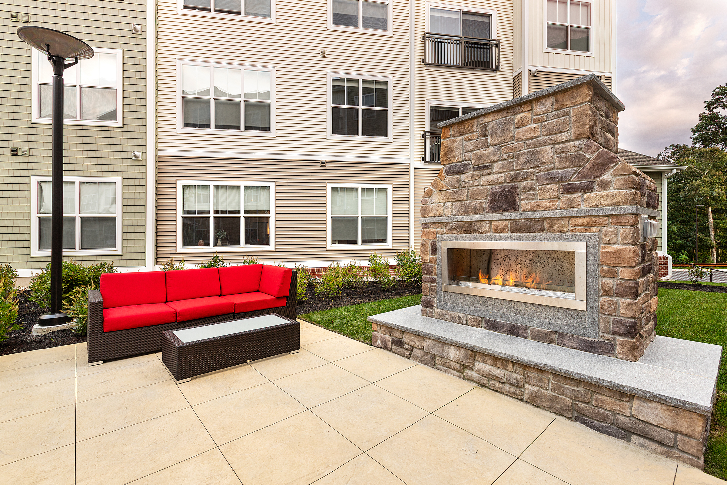 Patio with fireplace and seating.