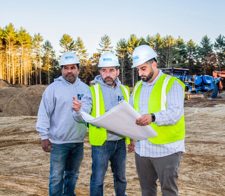 Dex by Terra workers looking at project plans on a commercial job site.