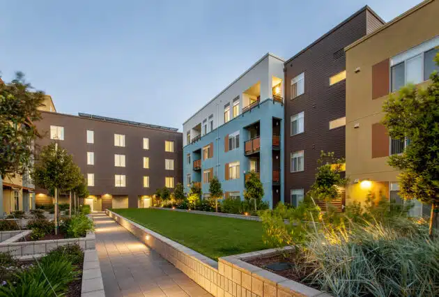 Luxury apartment complex courtyard with landscape lighting. Dex by Terra Commercial Services, Hudson, MA.